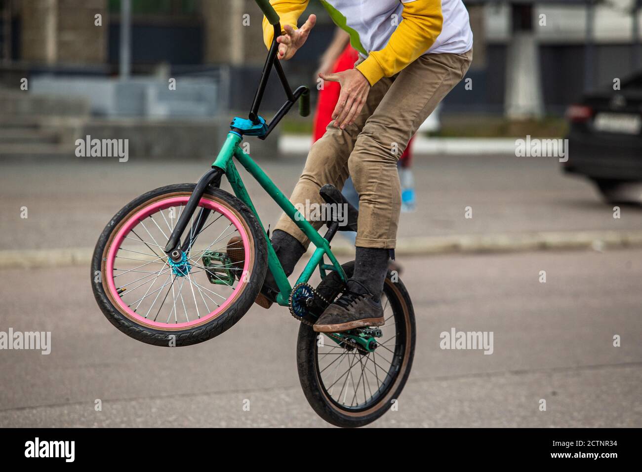 Bmx rider on black bmx in doing acrobtic stunts in the street. Urban ...