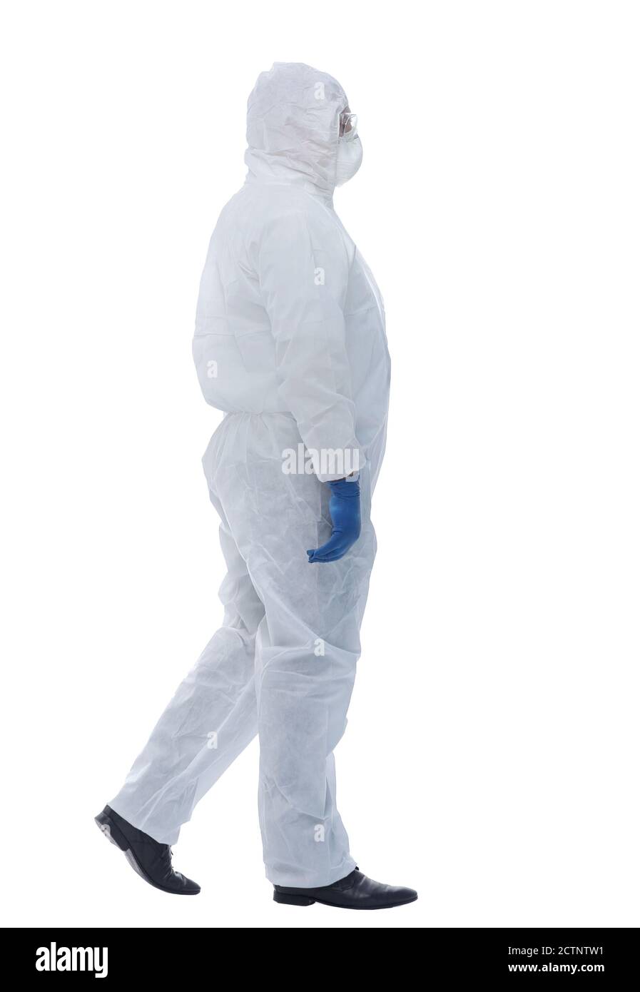full length . doctor in a biological protective suit striding forward Stock Photo