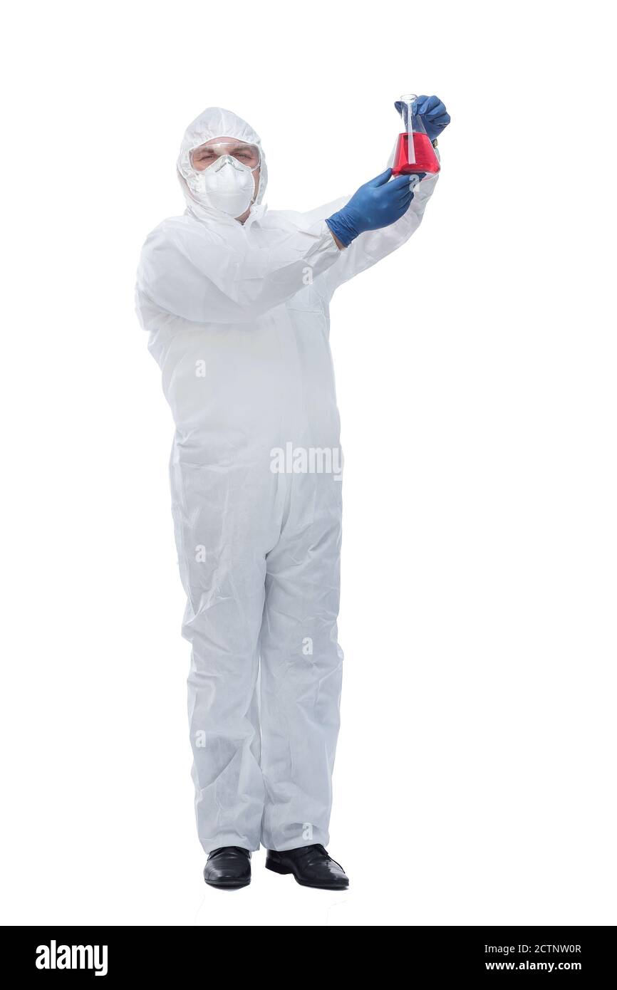 doctor in a biological-protective suit pointing to a vial of liquid Stock Photo