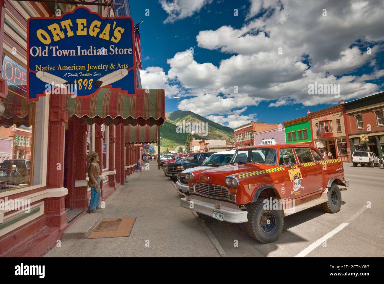 Checker taxicab, serving as advertisement for local Grumpy's Restaurant at Grand Imperial Hotel on Greene Street, Silverton, Colorado, USA Stock Photo