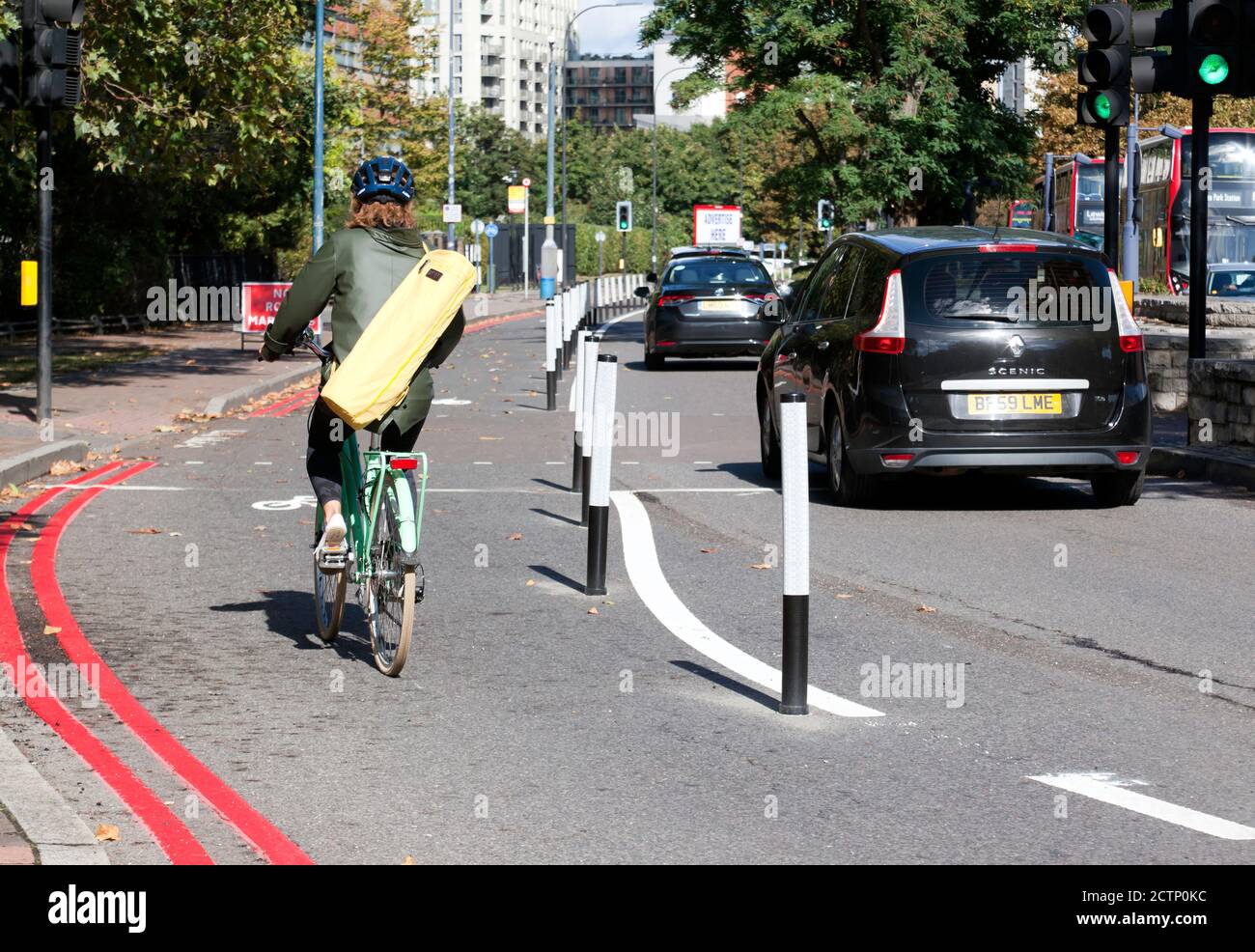 A Cyclist using the new temporary cycle lane along Molesworth Street, Lewisham, as part of a scheme to  improve walking & cycling Stock Photo