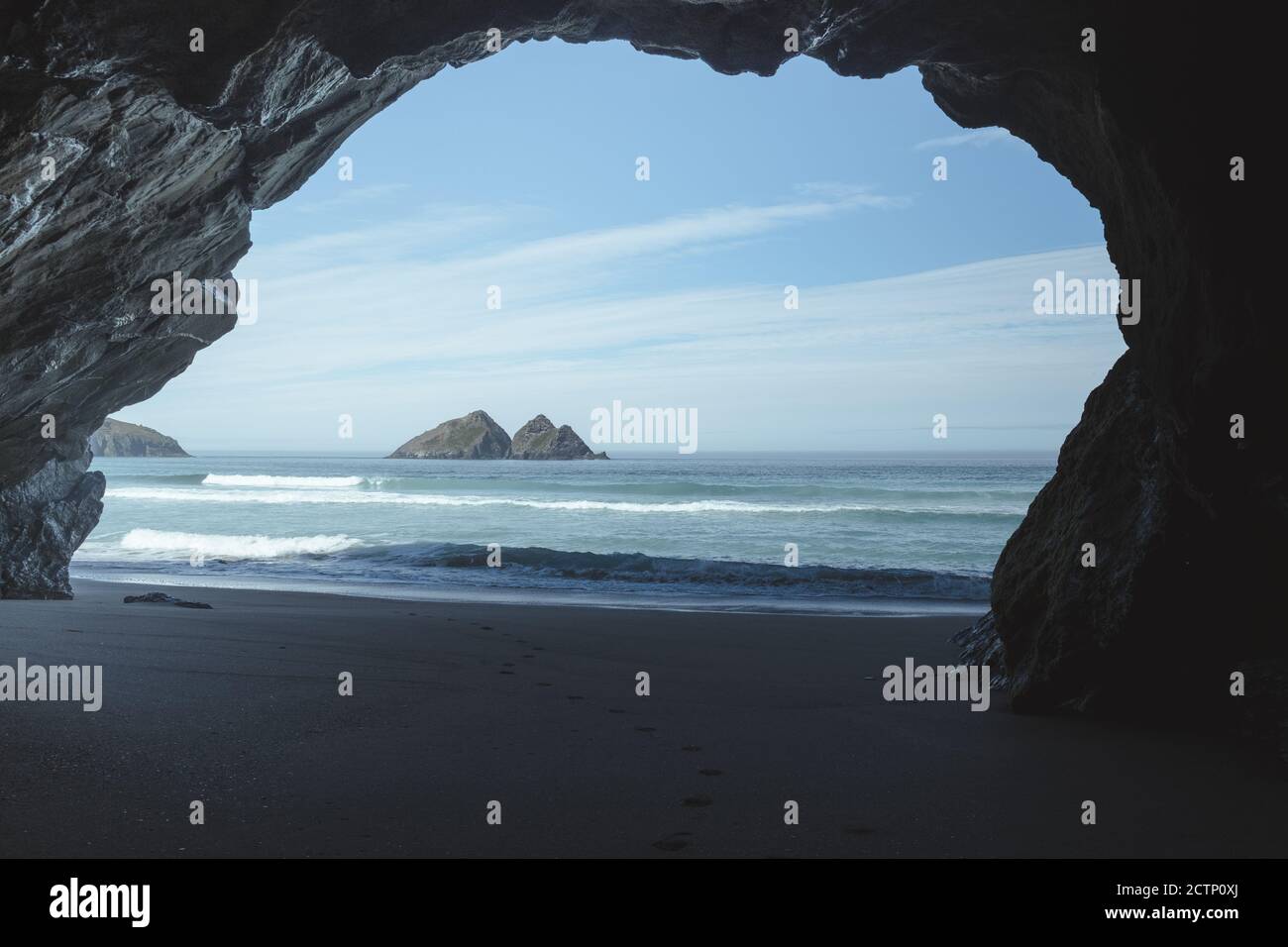 View of Gull Rock form Holywell Cave on Holywell Bay Beach Stock Photo