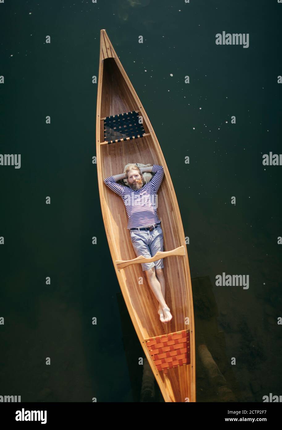 Single man relaxing in the canoe Stock Photo - Alamy
