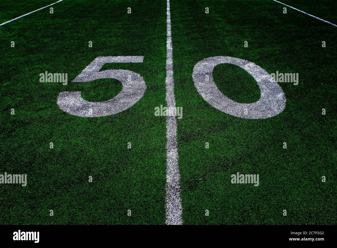 Football field green grass white yard markers to touchdown competition