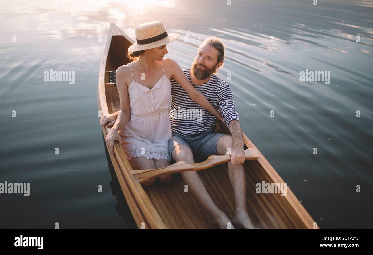 Couple enjoying a summer canoe ride Stock Photo - Alamy