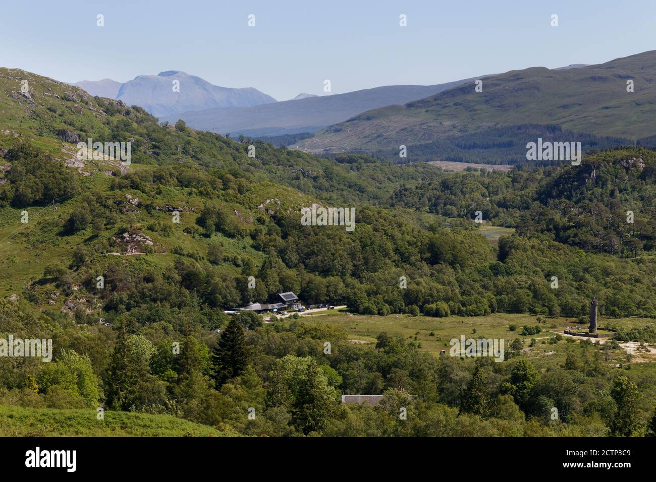 Glenfinnan Monument and Bonnie Prince Charlie statue with distant view of Ben Nevis Highlands Scotland Stock Photo