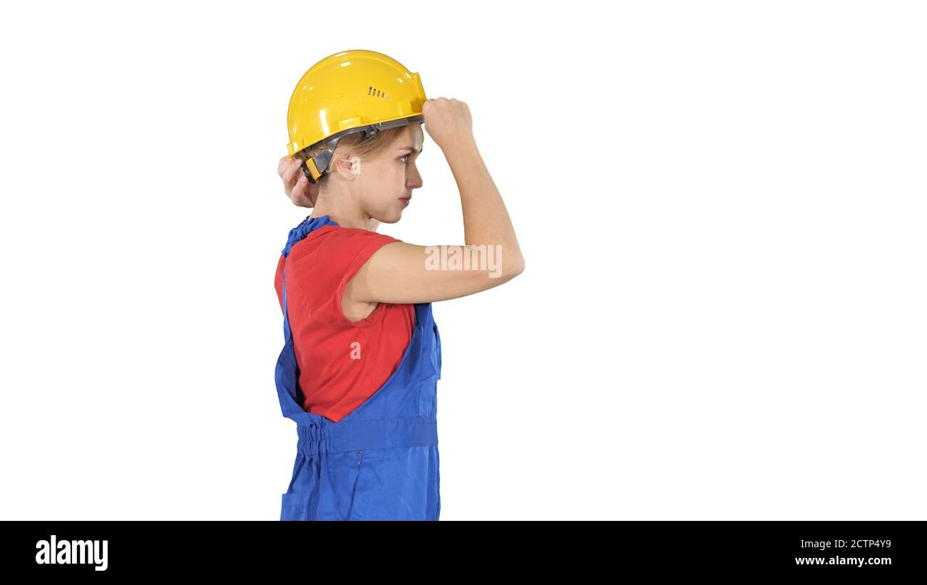 Young happy attractive woman in construction uniform putting yel Stock