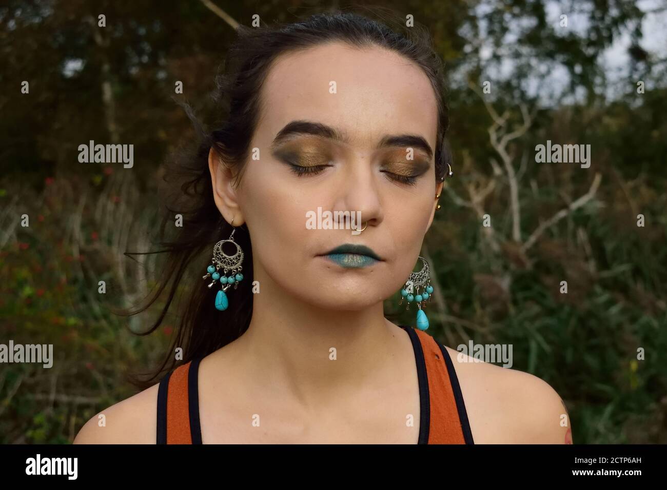 Young Person with Makeup Closing Their Eyes in the Breeze Stock Photo ...