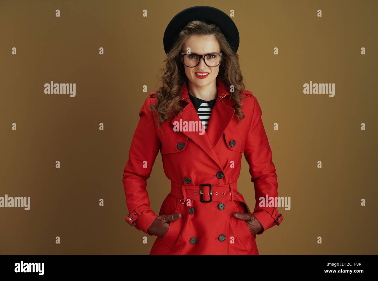 Hello september. happy stylish housewife in red coat and black beret with leather  gloves and glasses on beige background Stock Photo - Alamy