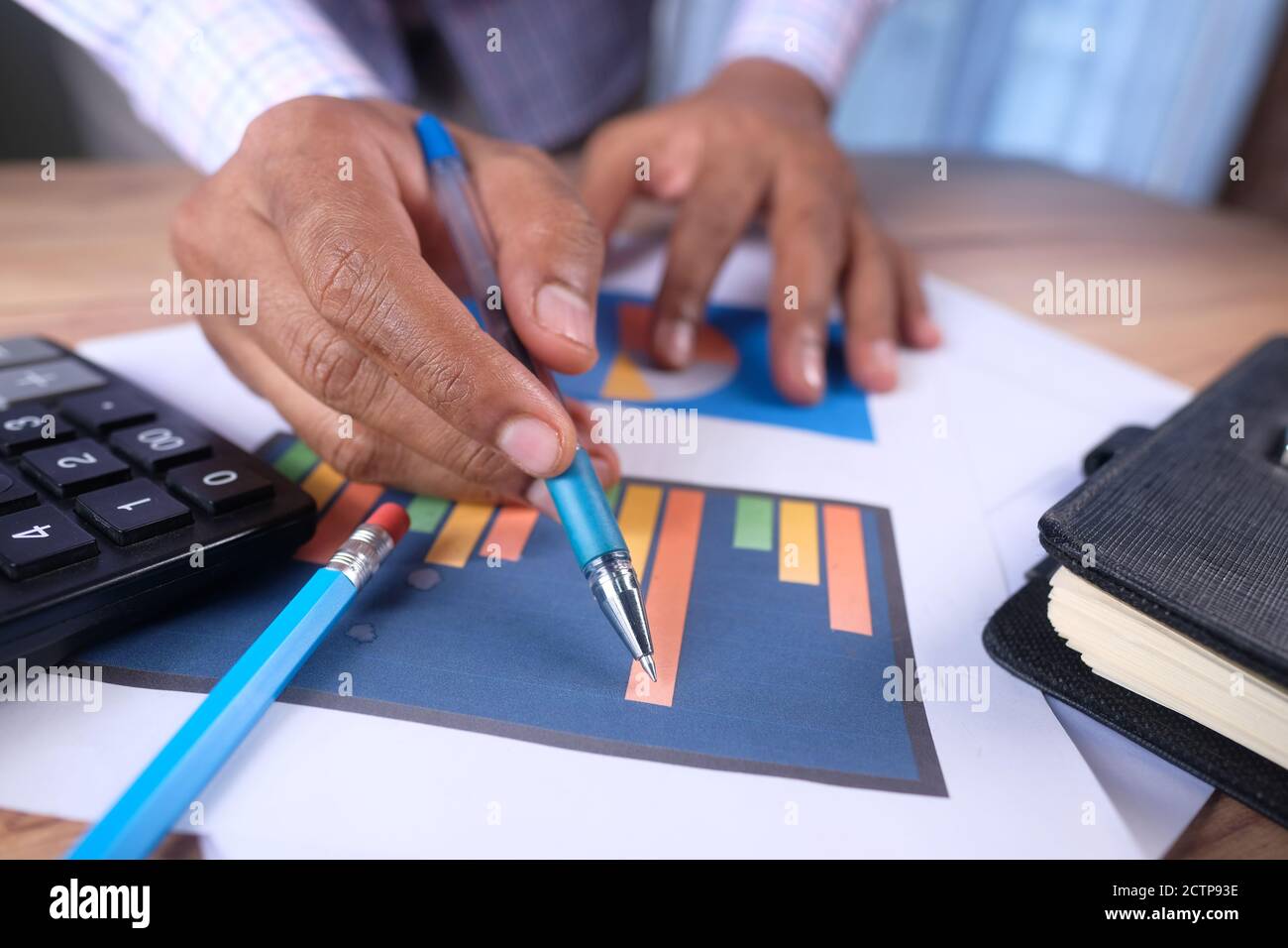 man hand with pen analyzing bar chart on paper Stock Photo - Alamy