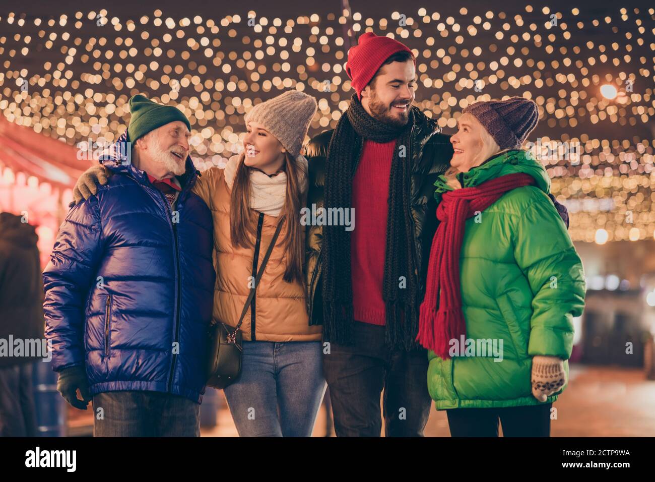 Photo of full family four members meeting embrace spend noel weekend together after long parting newyear miracle buy souvenirs multi-generation night Stock Photo