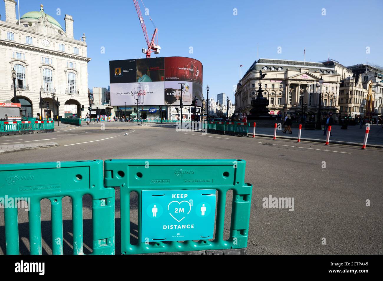 London, UK. - 20 Sept 2020: A sign - asking pedestrians to social distance - in front of an almost deserted Piccadilly Circus in the heart of London. Image taken on a weekday mid-morning when this area would normally be very busy. Stock Photo