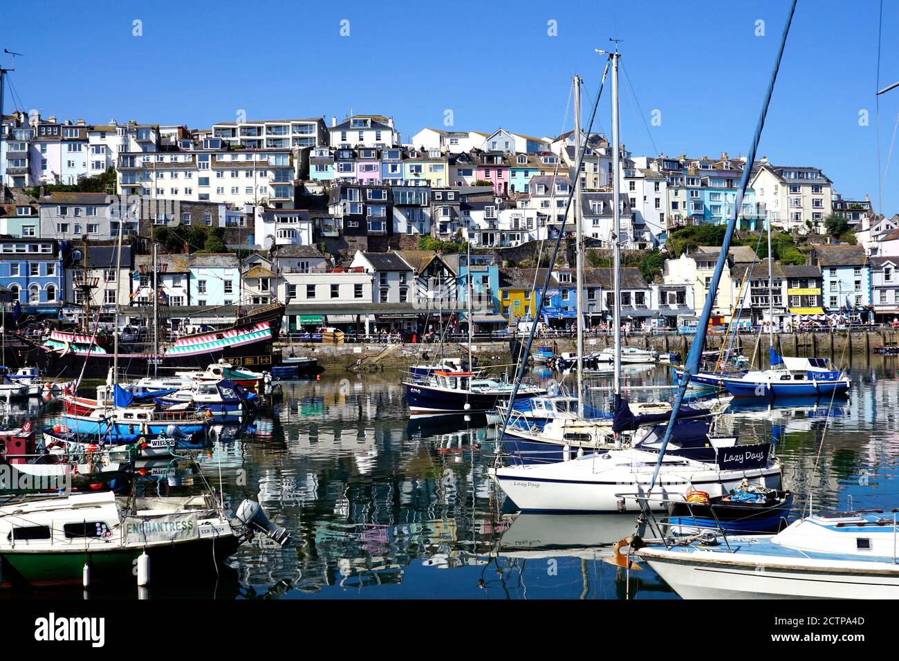 Brixham, Devon, UK.  September 14, 2020.  Tourists and holidaymakers enjoying the beautiful architecture and boats at the inner harbour of Brixham in Stock Photo