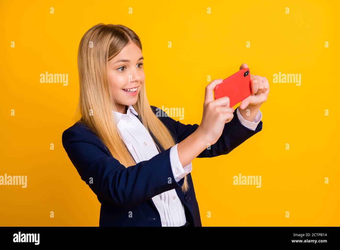 Close-up portrait of her she nice attractive addicted cheerful cheery long-haired girl using gadget playing game spending pause break isolated bright Stock Photo