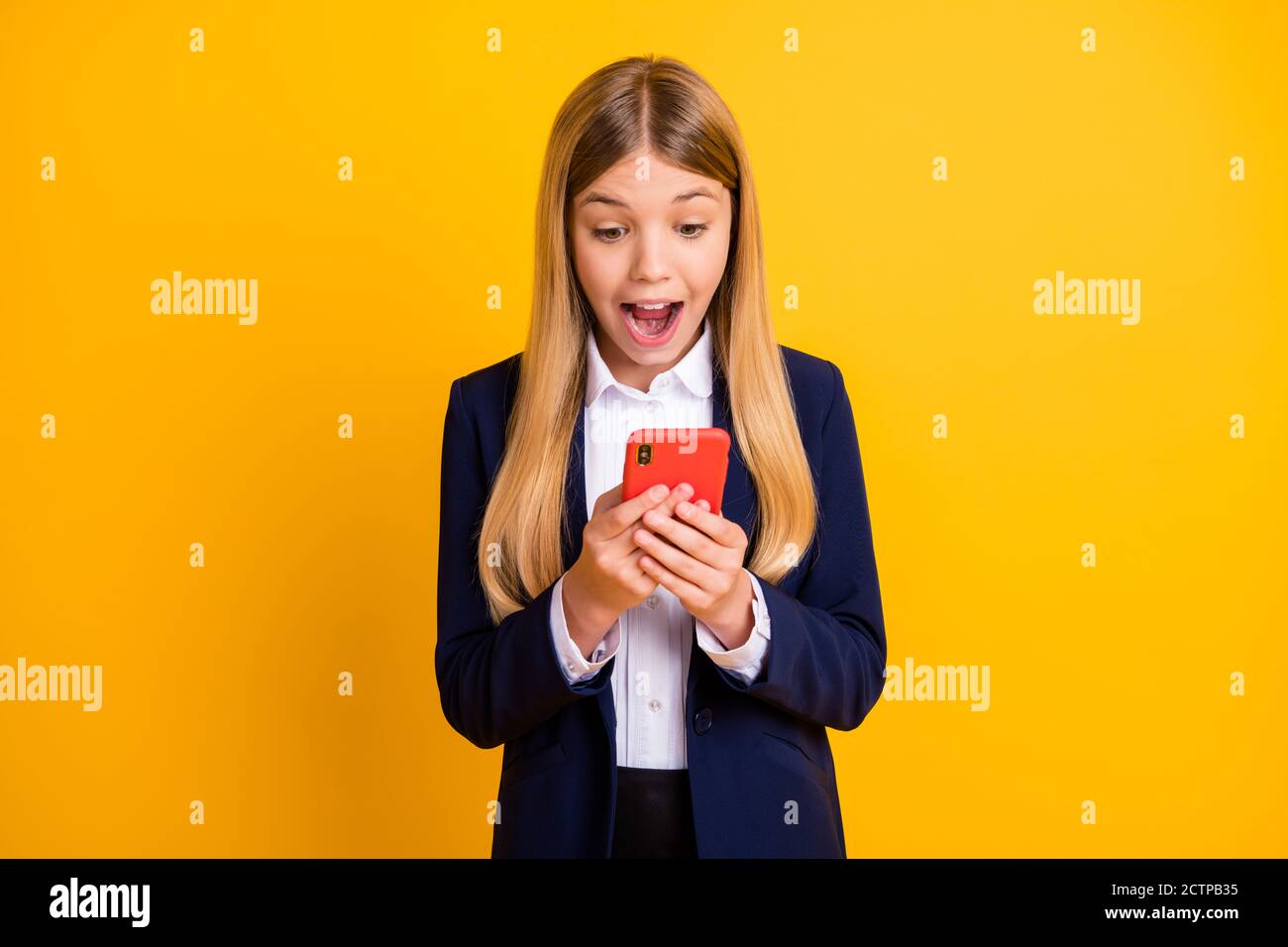 Portrait of her she nice attractive pretty amazed cheerful cheery long-haired girl using gadget reading notification win isolated bright vivid shine Stock Photo