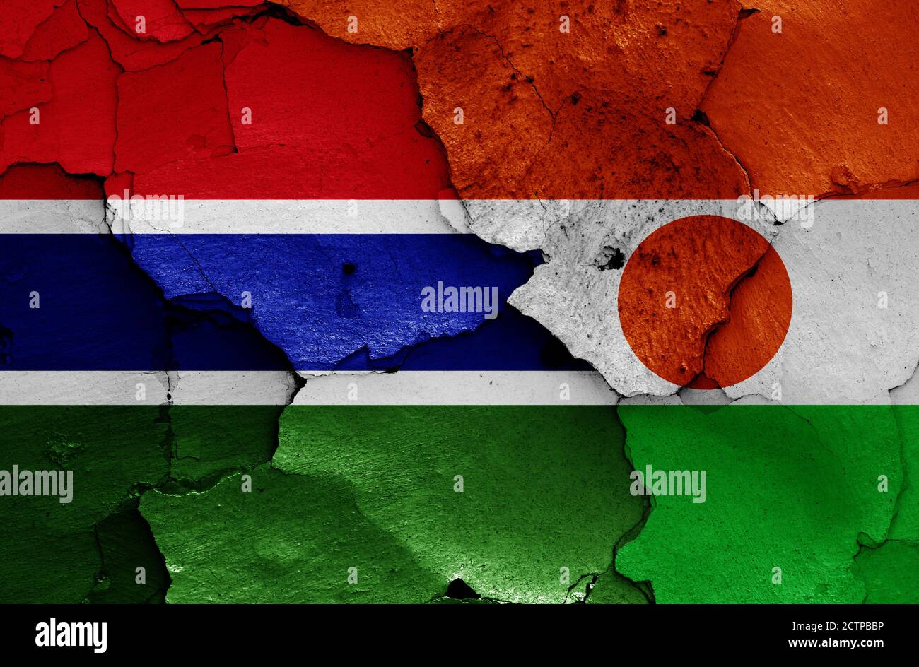 flags of Gambia and Niger painted on cracked wall Stock Photo