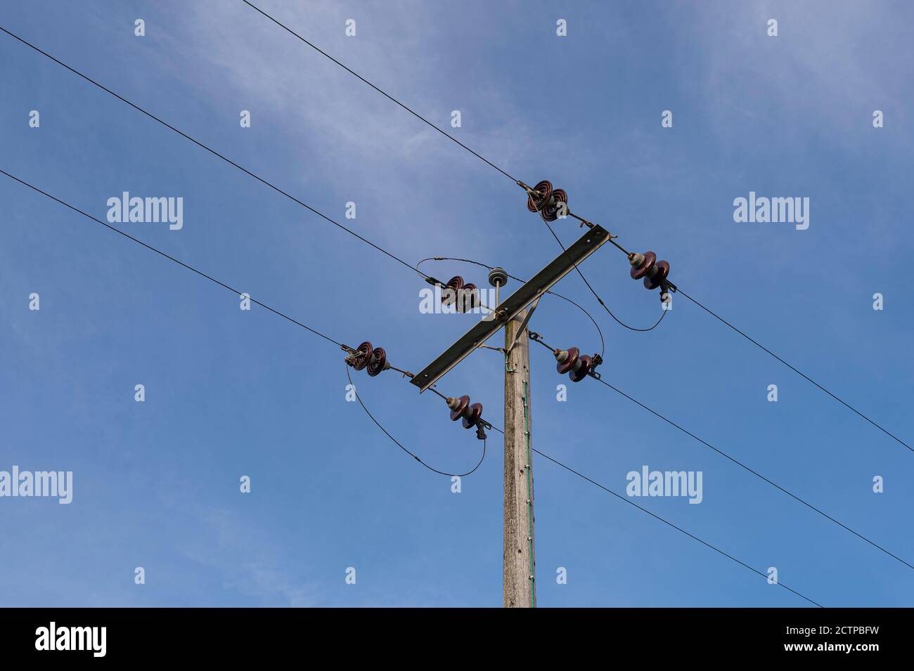 electricity supply cables against a blue sky Stock Photo