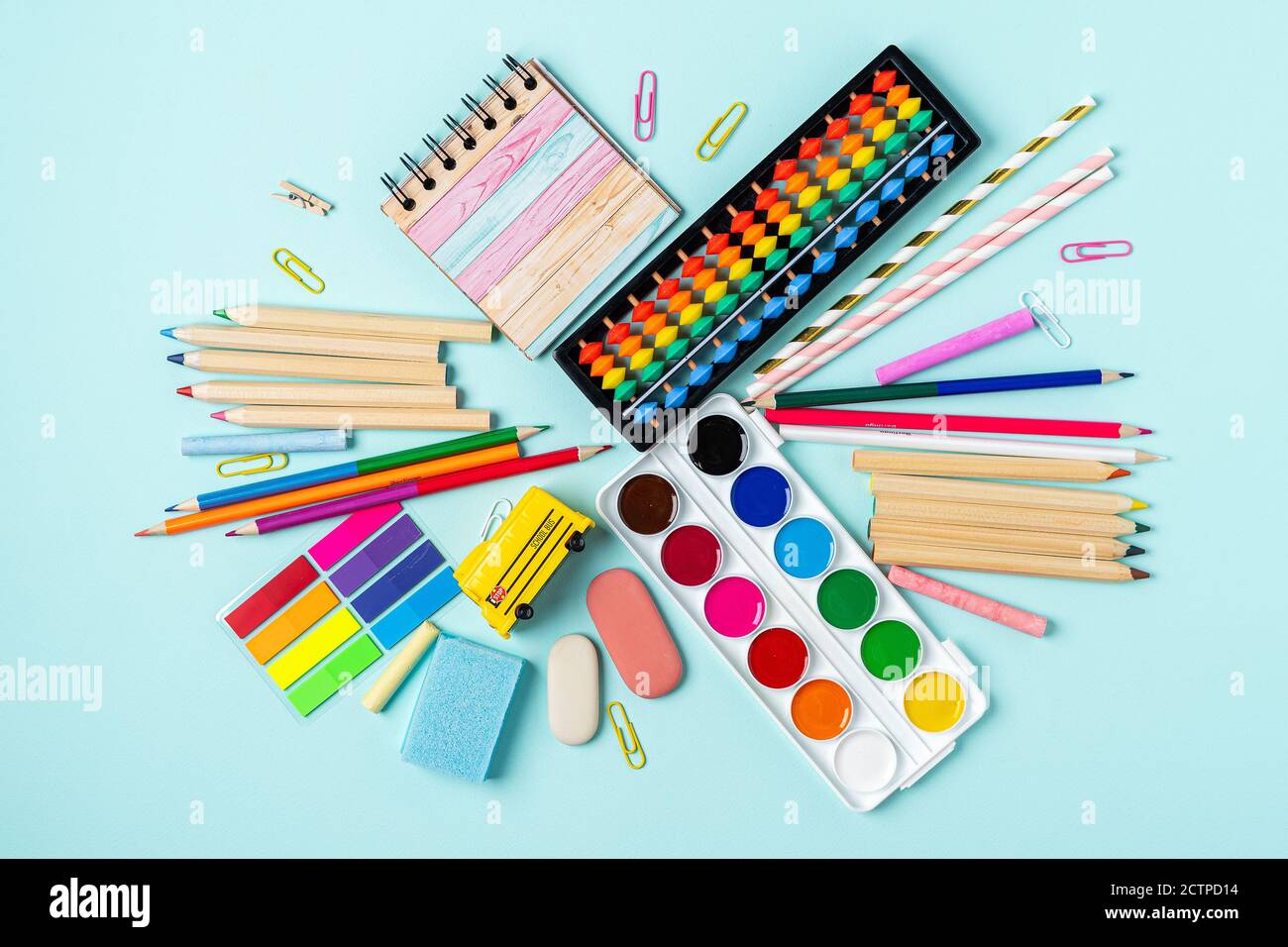 Flat lay of modern bright blue office desktop with school supplies on ...