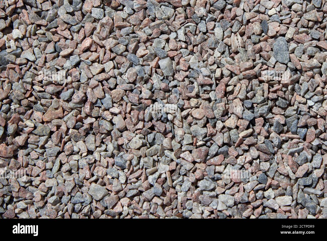 Crushed rock. Small rocks ground. Crushed stone road building