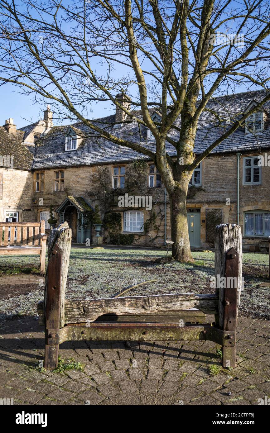Ancient wooden stocks in the market centre of Stow-on-the-wold, Gloucestershire, England Stock Photo