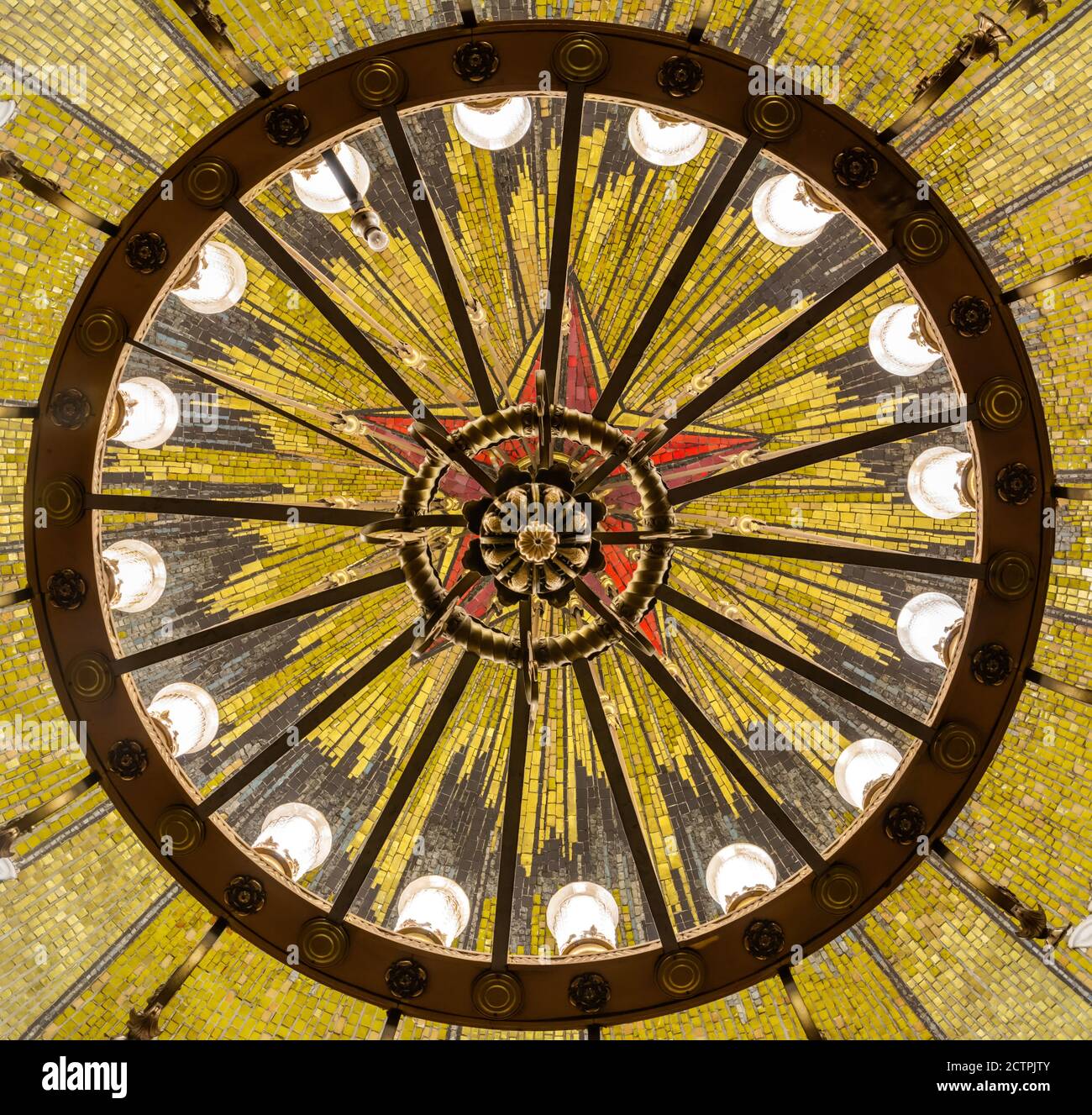 Moscow, Russia – July 4, 2017. Chandelier and mosaics depicting a Soviet five-pointed star on the ceiling of Komsomolskaya Metro station in Moscow. Stock Photo