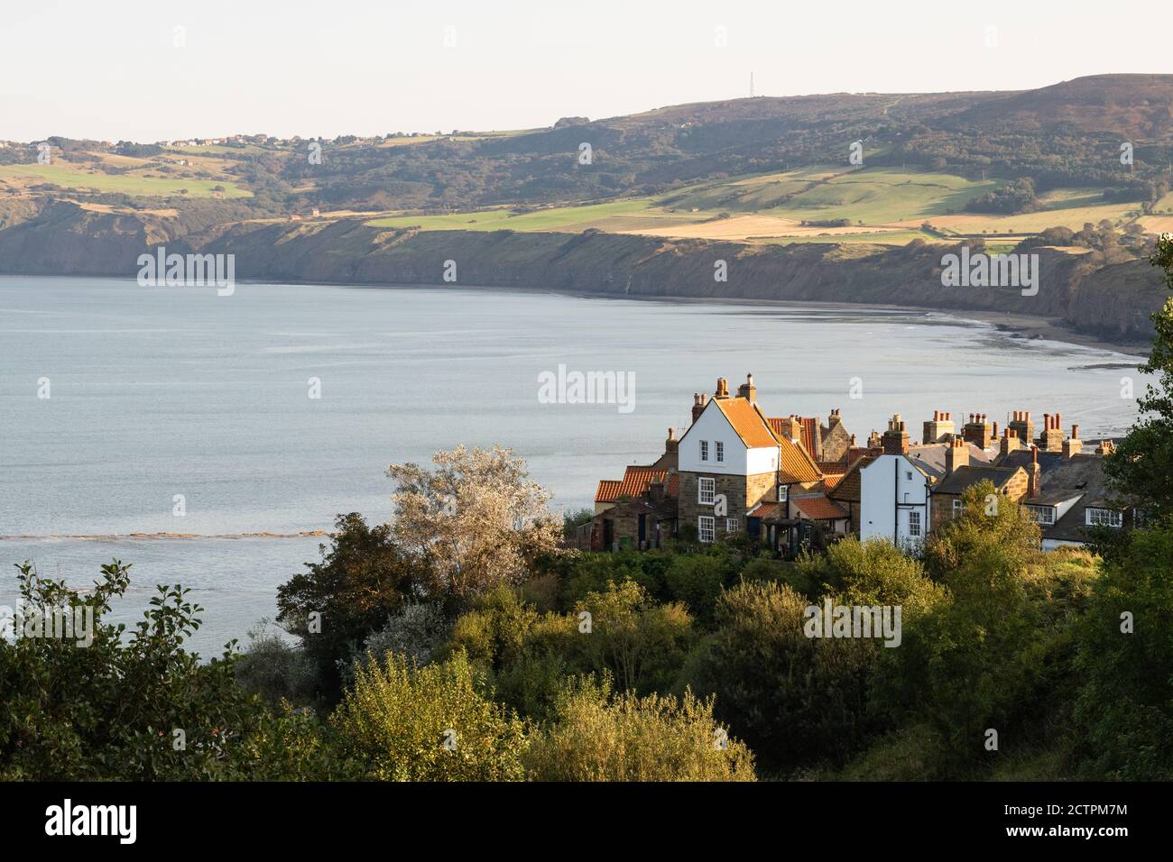 Robin Hoods Bay looking towards Ravenscar, North Yorkshire, England, UK from the clifftop footpath part of the Cleveland Way and Coast to Coast Walk Stock Photo