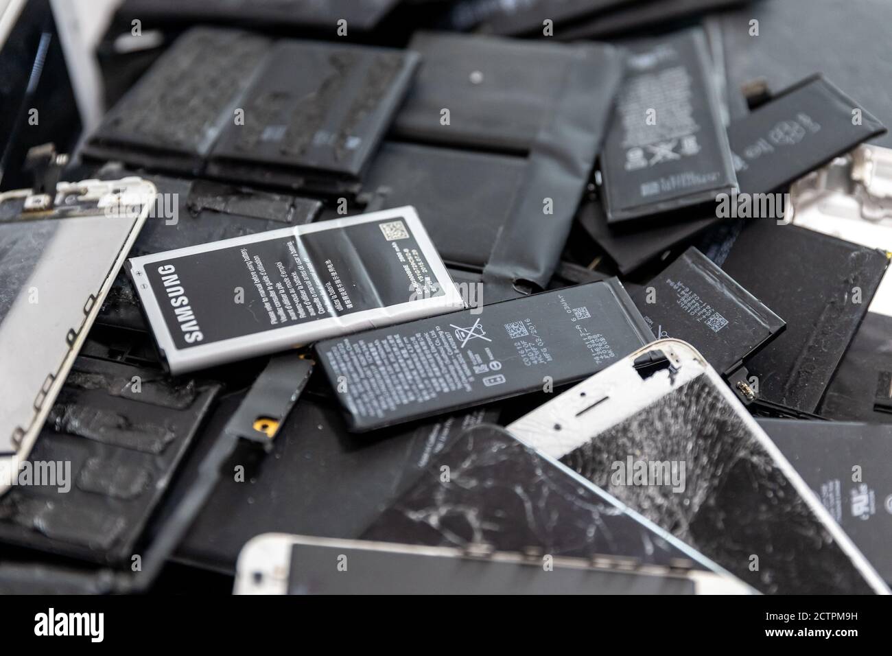 Broken iPhone Apple phone screens and used rechargeable batteries in  recycling repair shop, RUSSIA - July 27, 2020 Stock Photo - Alamy
