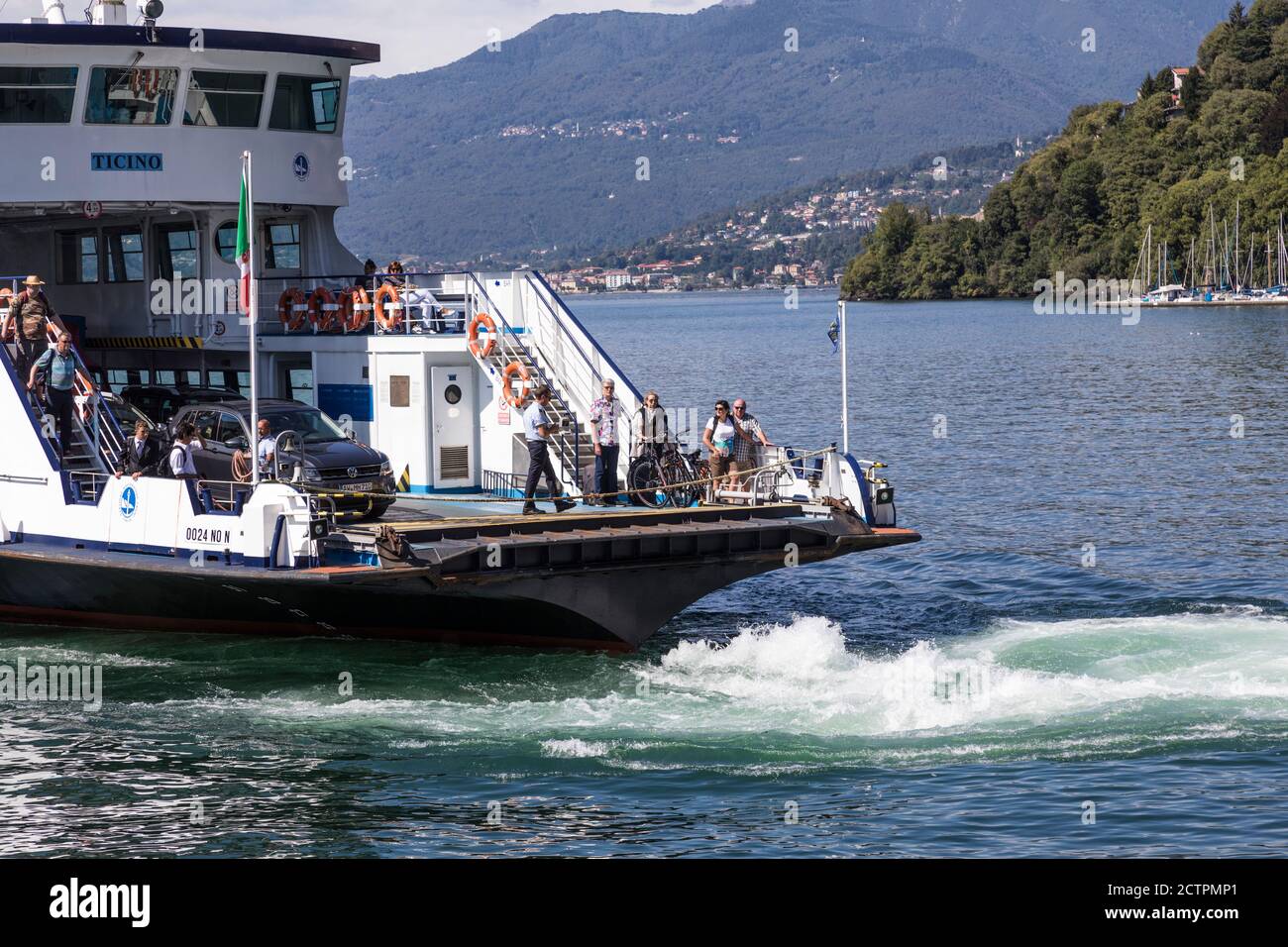 Car ferry aproaches the jetty at Laveno, Lake Maggiore (Lago Maggiore), Lombardy, Italy Stock Photo