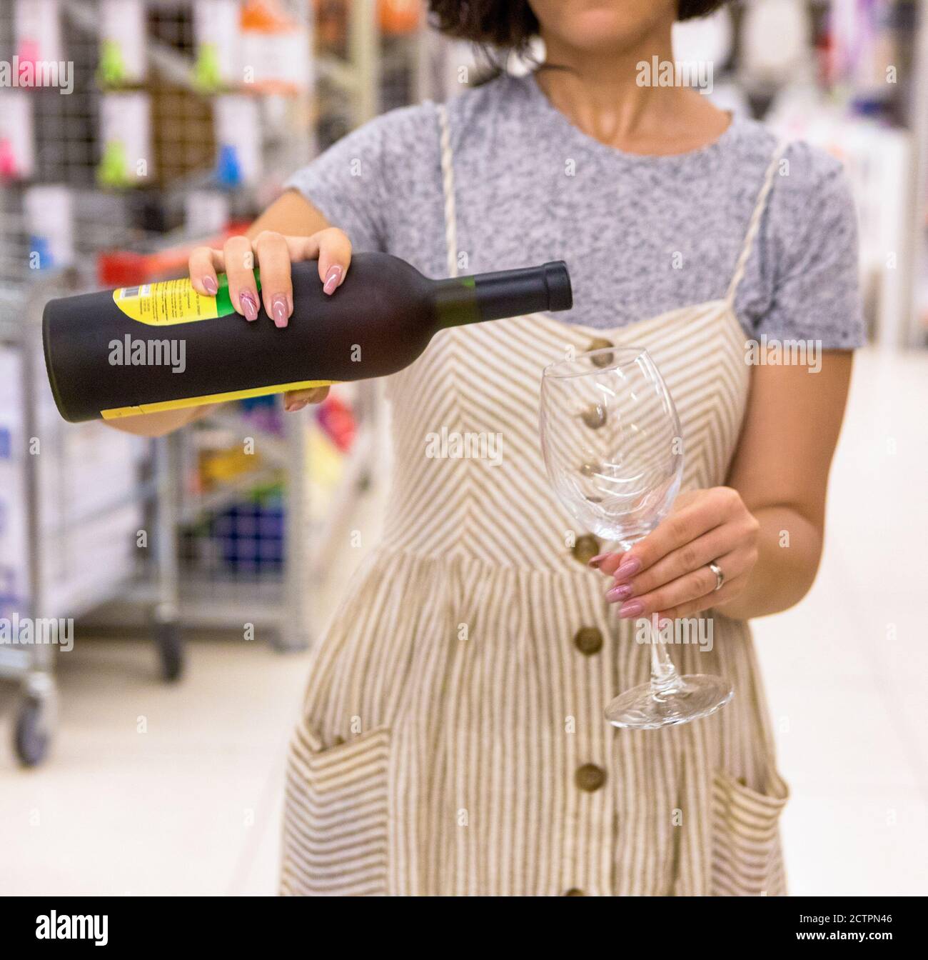 Woman pouring wine to the glass close up Stock Photo - Alamy