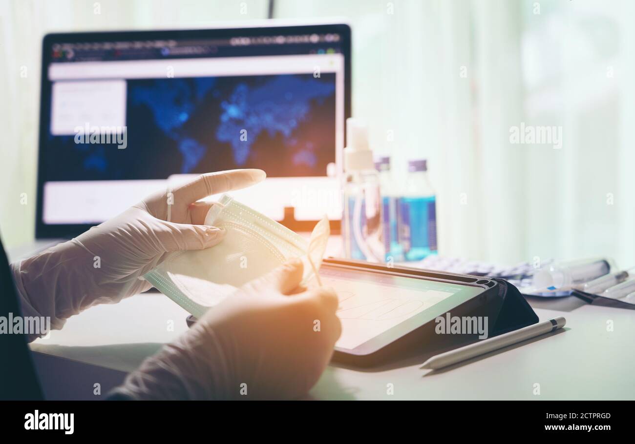 close up of doctor's hand with a medical face mask for protection against infection Stock Photo