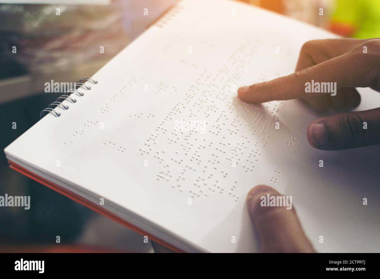 Closeup of fingers reading braille, Hand of a blind person reading