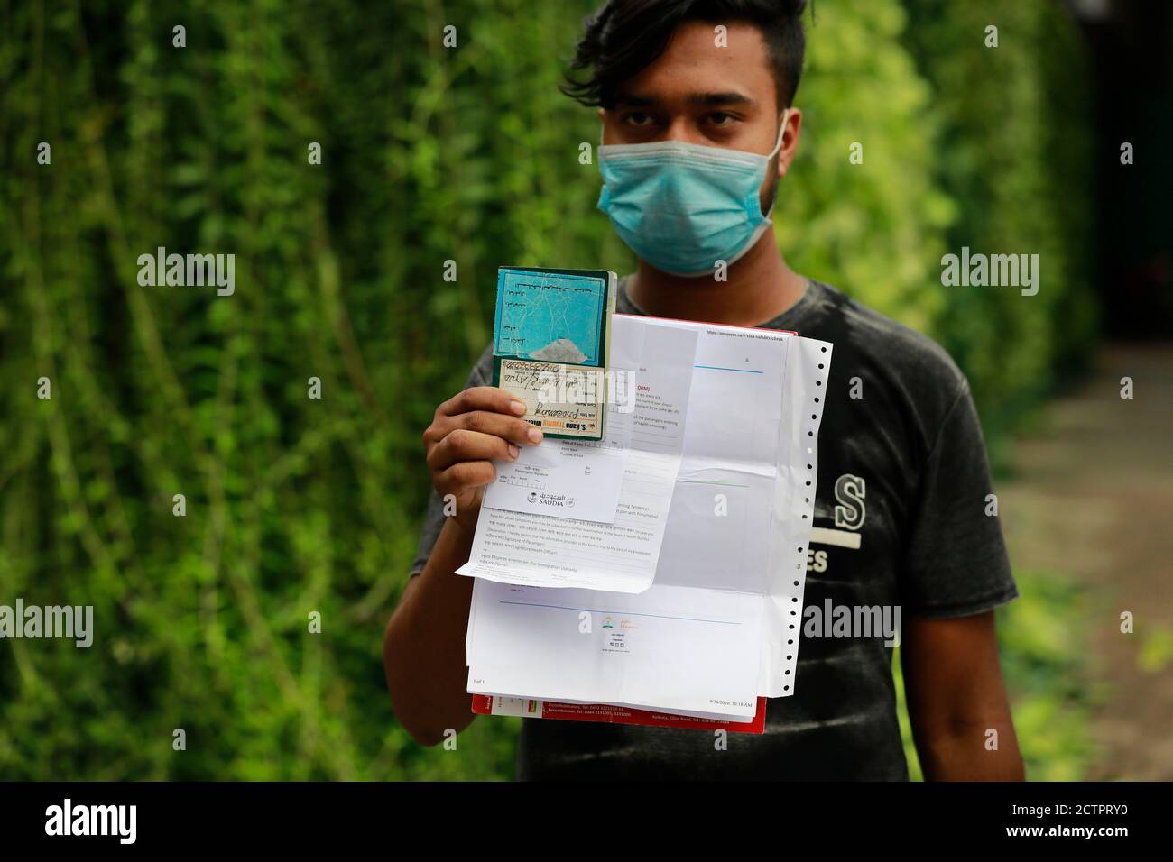 Dhaka, Bangladesh. 24th Sep, 2020. A Bangladeshi migrant worker shows his return ticket to go back to Saudi Arabia after, in Dhaka, Bangladesh, on September 24, 2020. Saudia has begun selling tickets in Dhaka, ending days of wait and demonstration by stranded Bangladeshi migrant workers. At least 30,000 Bangladeshi expatriate workers are waiting to return to their workplaces in Saudi Arabia, said an official of Saudi Airlines. More than 2 million Bangladeshi expatriates work in Saudi Arabia. Nearly half of the $18.2 billion remittances received by Bangladesh in the 2019-20 fiscal years cam Stock Photo