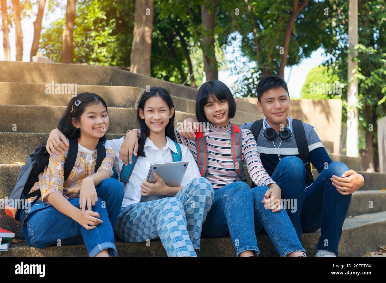 Group student young people and education reading book in city park Stock Photo