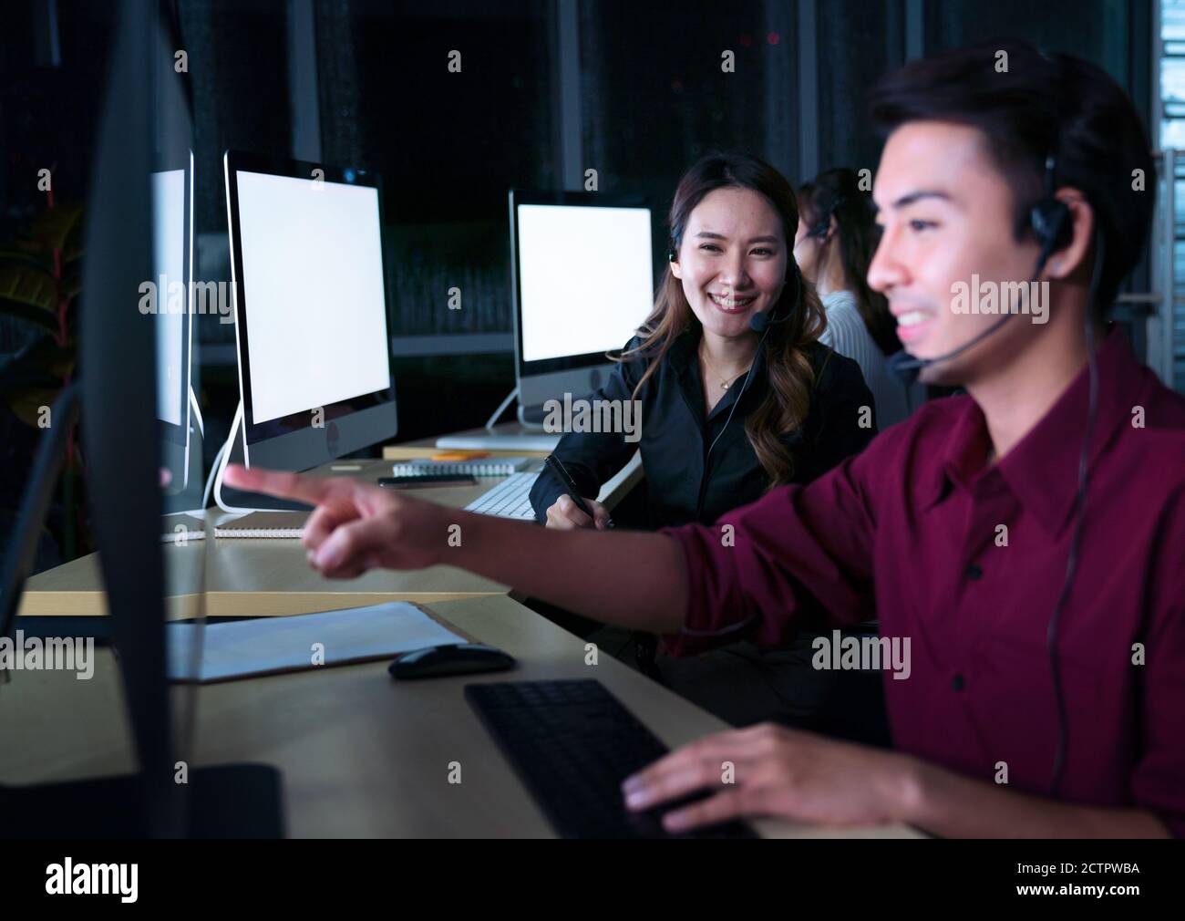 Young Thai Asian customer services care operators working night shift