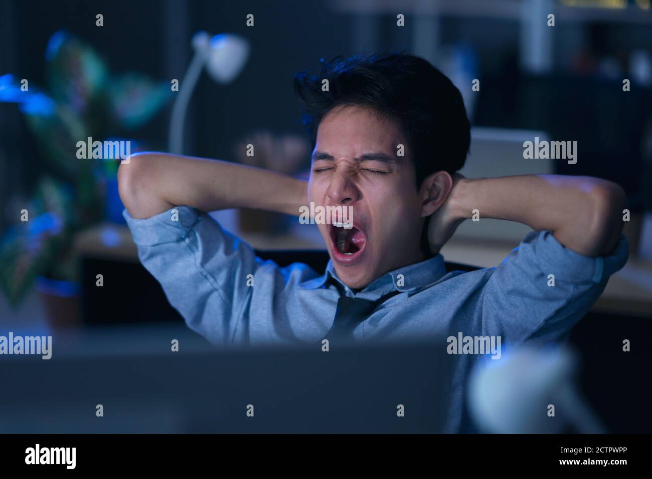 Businessman in the office at night working late Stock Photo