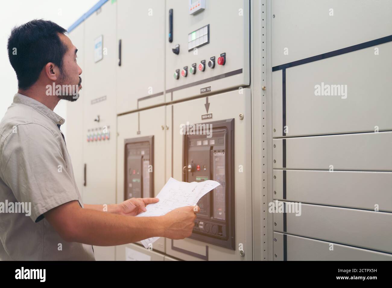 Electrical engineer man checking voltage and test at the Power