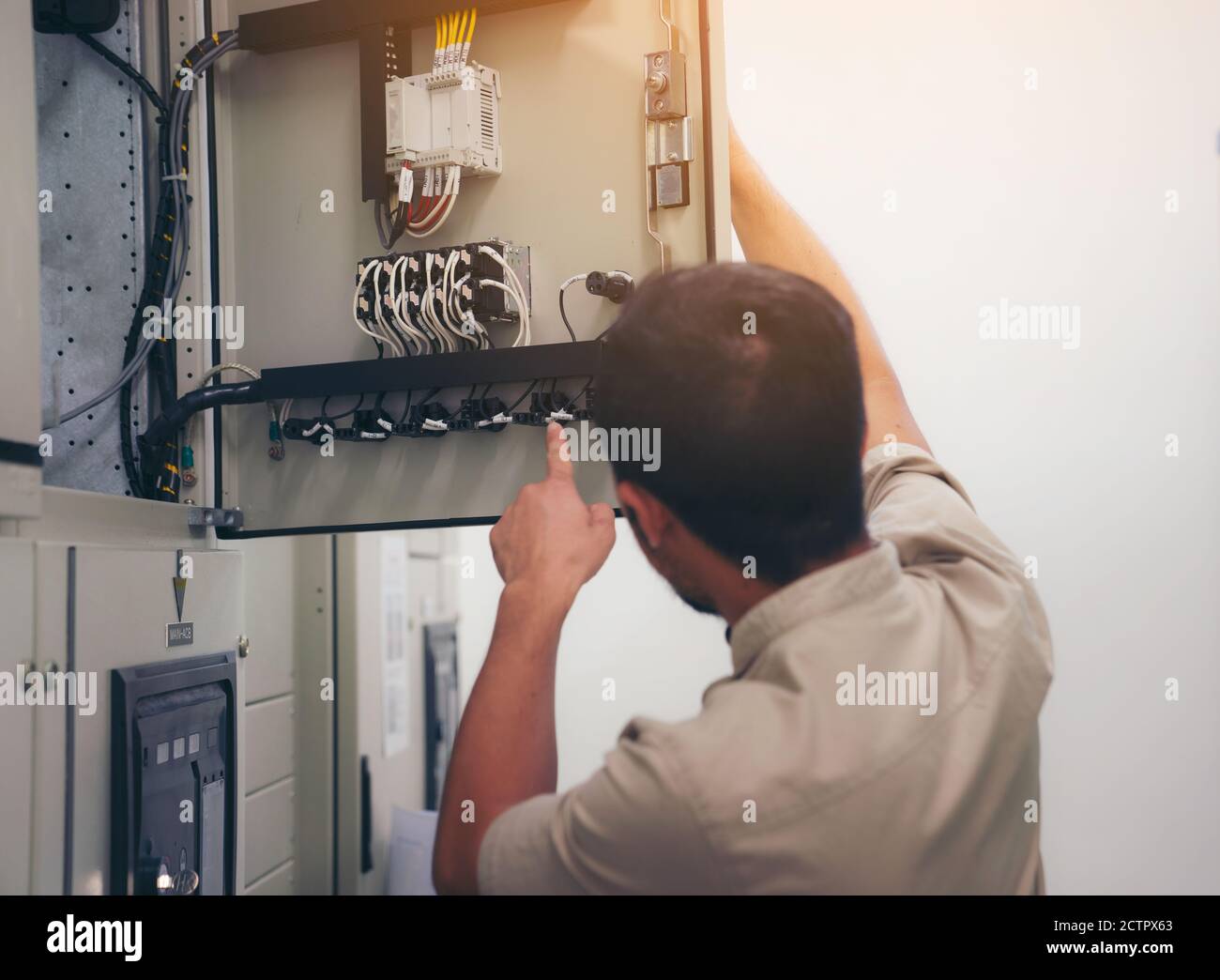 Electrical engineer man checking voltage and test at the Power