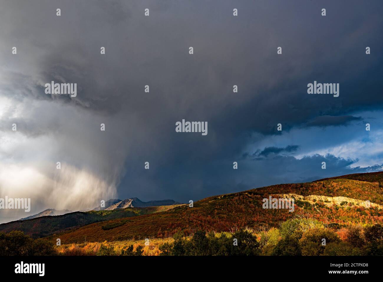 Thunderstorm in the mountains.  Quick and sometimes violent thunderstorms can develop over the high mountains of Utah, USA in the Fall. Stock Photo