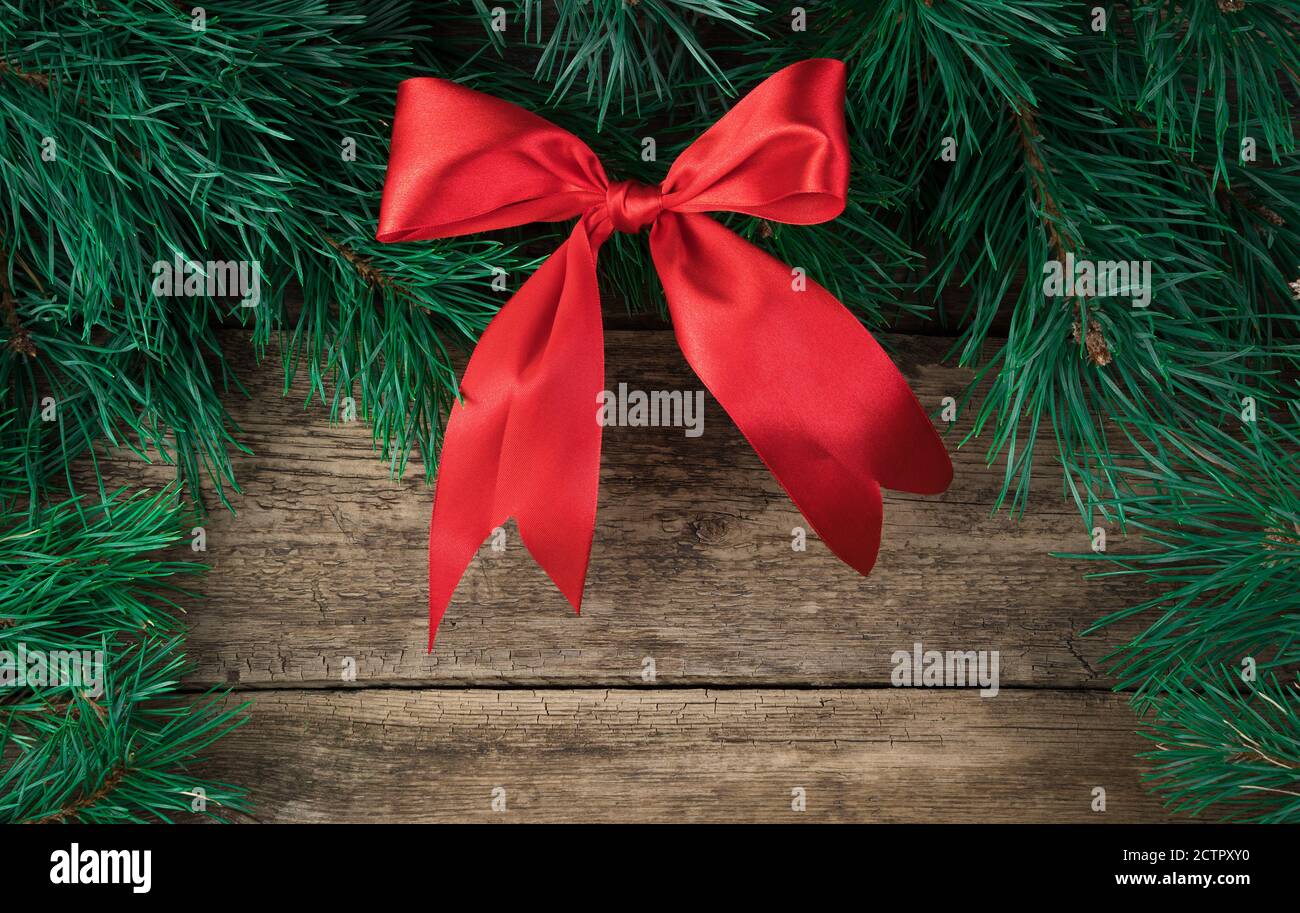 Christmas decorations made of red satin and fir branches of a bow on a ...