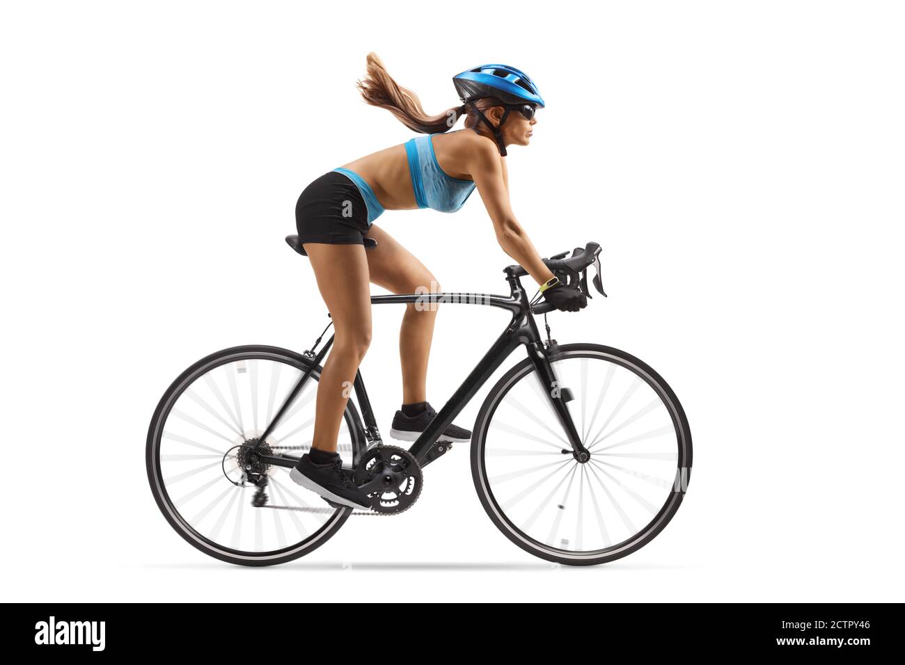 Full length profile shot of a female cyclist riding a bicycle with a helmet isolated on white background Stock Photo