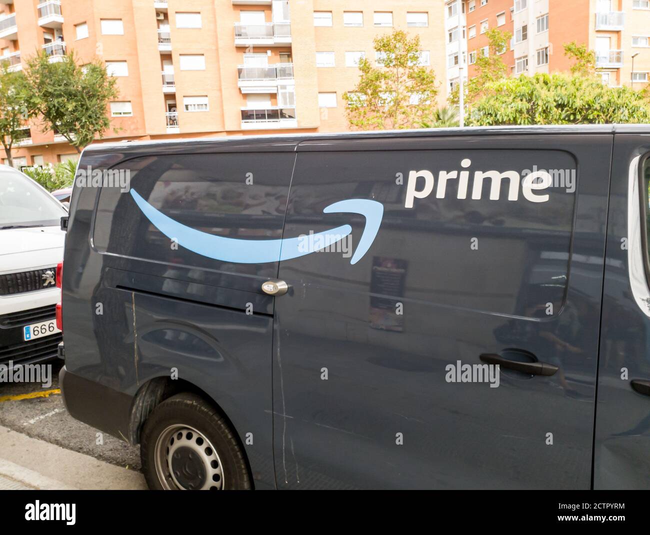 Amazon Prime's delivery van makes deliveries in a suburban neighborhood