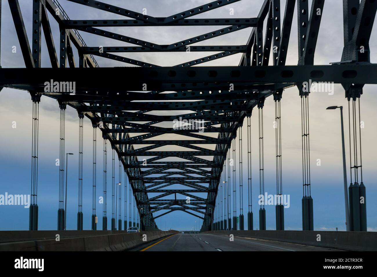 View of the metal bridge in perspective across the river, arched structure Stock Photo