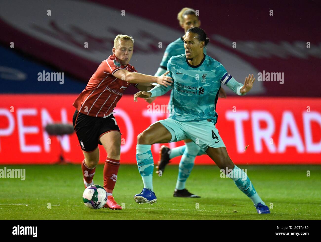 Lincoln City's Anthony Scully (left) and Liverpool's Virgil van Dijk