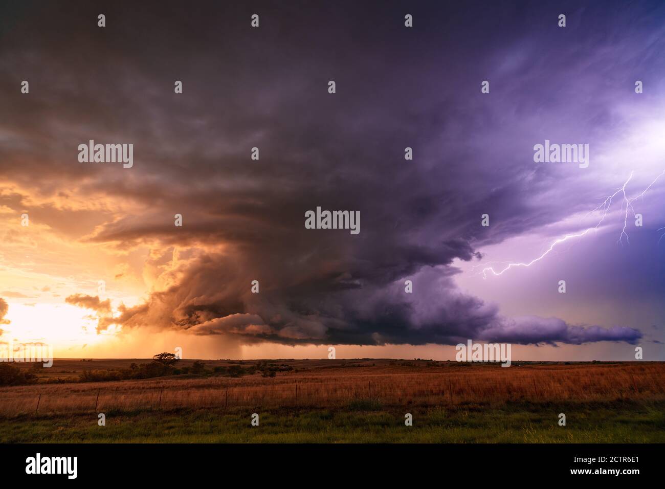 Scenic landscape with supercell thunderstorm clouds and lightning in a sunset sky near Strong City, Oklahoma Stock Photo