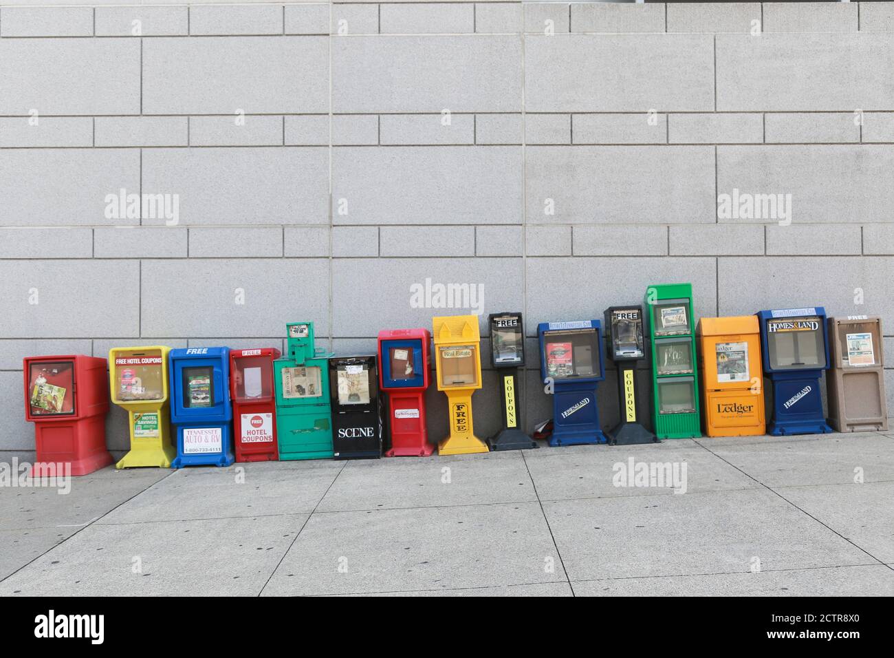 Row of Colorful Newspaper Boxes on Sloping Sidewalk, Nashville, Tennessee, USA Stock Photo