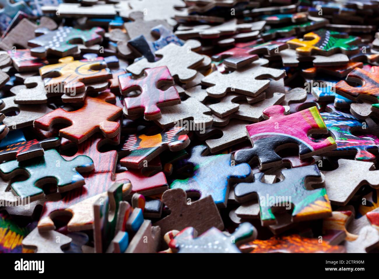 Disassembled puzzle colored pieces Stock Photo