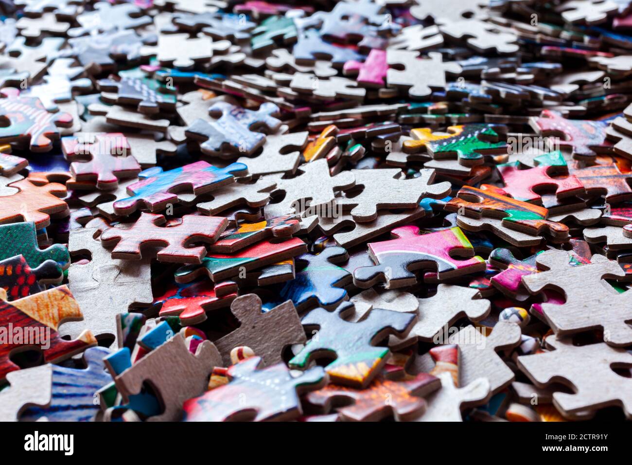 Disassembled puzzle colored pieces Stock Photo