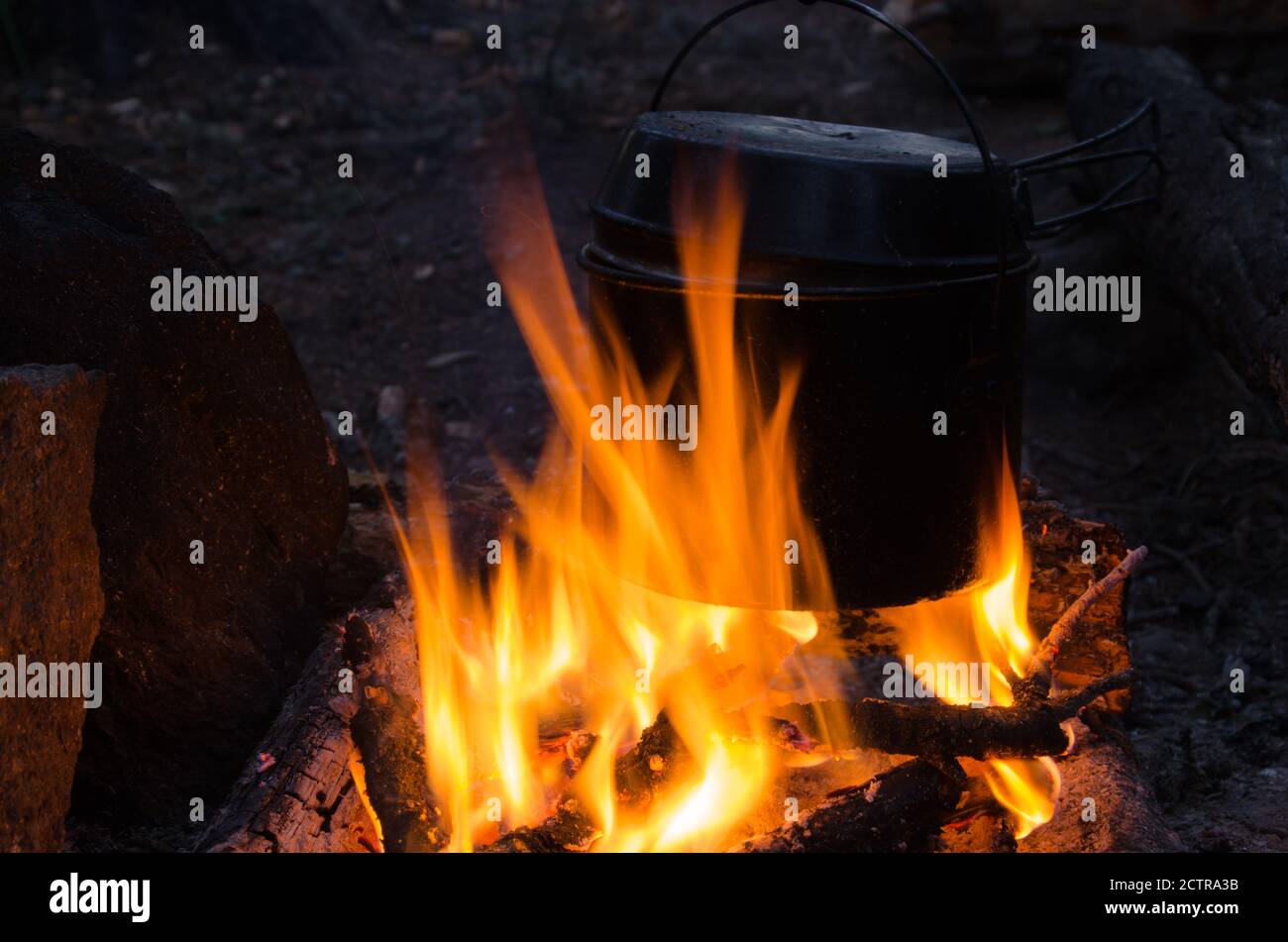 fire burns in the campaign. pot of tea by the fire Stock Photo