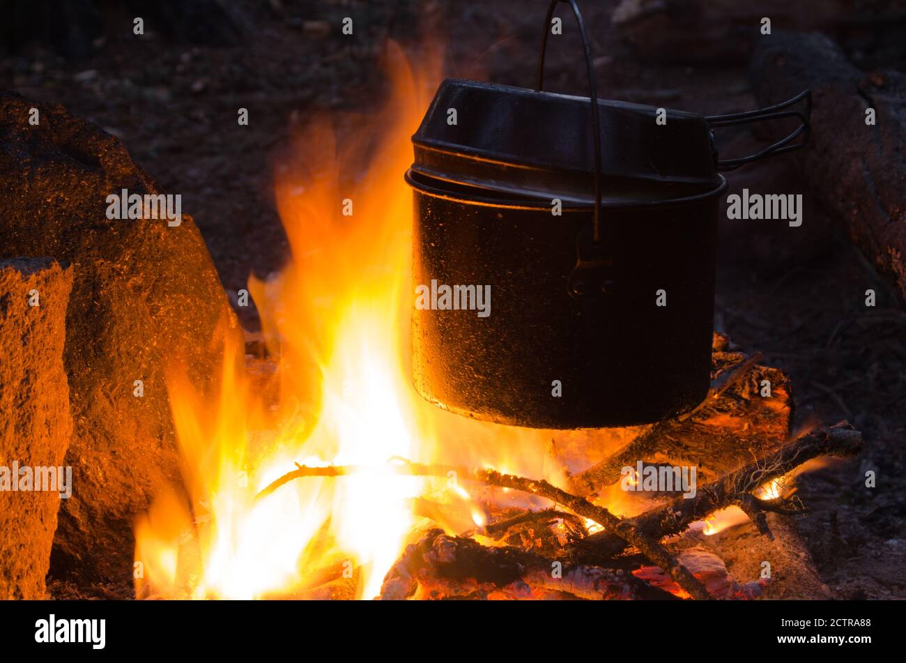 fire burns in the campaign. pot of tea by the fire Stock Photo