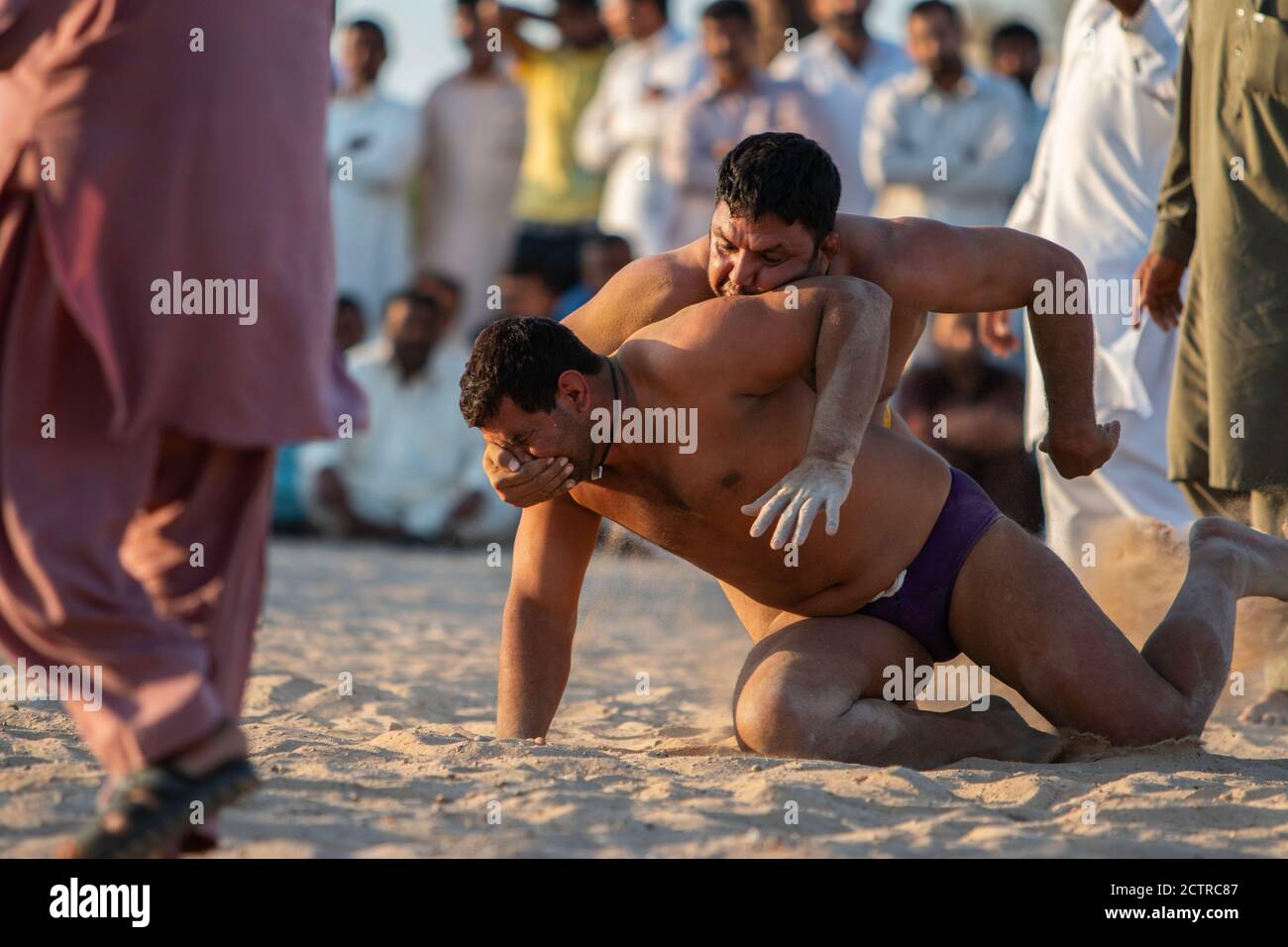 Kusti wrestler tries to submit another wrestler by placing his hand over his mouth in a match in Dubai, United Arab Emirates (UAE) Stock Photo